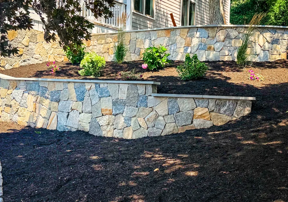 Stone retaining wall and planting bed